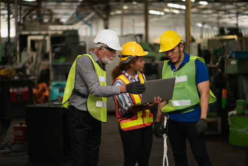Technical team workers discussing around a laptop