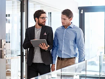 two businessmen walking and talking
